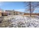 Spacious backyard with patio and snow-covered lawn at 2681 S Newport St, Denver, CO 80224