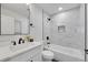 Updated bathroom with white vanity, bathtub, and modern fixtures at 2681 S Newport St, Denver, CO 80224