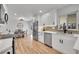 Modern kitchen with white cabinets, stainless steel appliances, and a large island at 2681 S Newport St, Denver, CO 80224