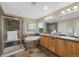 Main bathroom featuring a tiled shower, soaking tub, double sink vanity, and natural light at 4821 Bluegate Dr, Highlands Ranch, CO 80130