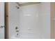 Bathroom with a shower and tub combo with white tiling at 4821 Bluegate Dr, Highlands Ranch, CO 80130