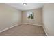 Spare bedroom with neutral paint, carpeting, and a large window overlooking the front yard at 4821 Bluegate Dr, Highlands Ranch, CO 80130