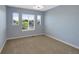 Bedroom with neutral carpet and three windows providing natural light at 4821 Bluegate Dr, Highlands Ranch, CO 80130