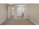 Upstairs bonus room with neutral carpet and paint leading to two doorways and a built-in desk area at 4821 Bluegate Dr, Highlands Ranch, CO 80130