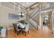 Elegant dining room with hardwood floors and stylish chandelier, adjacent staircase at 4821 Bluegate Dr, Highlands Ranch, CO 80130
