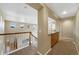 Upstairs hallway featuring a charming staircase, a built-in counter, and neutral carpeting at 4821 Bluegate Dr, Highlands Ranch, CO 80130