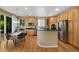 Bright kitchen with stainless steel appliances, granite countertops, and a breakfast nook with a view to the backyard at 4821 Bluegate Dr, Highlands Ranch, CO 80130