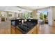 Open-concept kitchen and living area with a gas cooktop, granite countertops, and hardwood floors at 4821 Bluegate Dr, Highlands Ranch, CO 80130