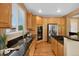 Modern kitchen with stainless steel appliances, granite countertops, hardwood floors, and ample cabinet space at 4821 Bluegate Dr, Highlands Ranch, CO 80130