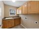 Laundry room with plenty of storage, tile floors, and sink at 4821 Bluegate Dr, Highlands Ranch, CO 80130