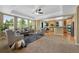 Spacious living room with large windows, comfortable seating, and an open concept design at 4821 Bluegate Dr, Highlands Ranch, CO 80130