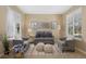 Comfortable living room with neutral tones, stylish seating, and lots of light at 4821 Bluegate Dr, Highlands Ranch, CO 80130