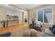 Cozy living space with hardwood floors, leading to staircase and dining area at 4821 Bluegate Dr, Highlands Ranch, CO 80130
