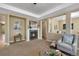 Cozy living room featuring a fireplace, tray ceiling, and comfortable seating at 4821 Bluegate Dr, Highlands Ranch, CO 80130
