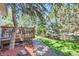 Backyard deck surrounded by mature trees, a stone pathway and lush lawn at 11803 E 114Th Pl, Commerce City, CO 80640