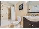Well-lit bathroom with a combined bathtub and shower, a framed mirror, and a pedestal sink at 11803 E 114Th Pl, Commerce City, CO 80640