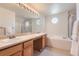 Spacious bathroom featuring double sinks, vanity lighting, and a separate shower and tub at 11803 E 114Th Pl, Commerce City, CO 80640