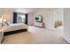 Spacious bedroom with vaulted ceilings, a large window, and a decorative mirror on top of the dresser at 11803 E 114Th Pl, Commerce City, CO 80640