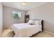 Comfortable bedroom offers natural light, a queen bed, and a calm, inviting atmosphere at 11803 E 114Th Pl, Commerce City, CO 80640