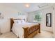 Cozy bedroom boasts natural light, a wooden bed frame, and a tranquil ambiance at 11803 E 114Th Pl, Commerce City, CO 80640