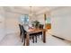 Cozy dining room with tray ceiling, chandelier, and large window at 11803 E 114Th Pl, Commerce City, CO 80640