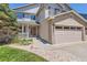Charming two-story home with a brick-accented garage, a well-manicured lawn, and a cozy front porch at 11803 E 114Th Pl, Commerce City, CO 80640