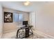 Bright home office features black desk, neutral walls, and a window that provides natural light at 11803 E 114Th Pl, Commerce City, CO 80640