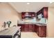 The kitchen features dark wood cabinets, granite counters, stainless appliances, and a cozy dining area at 11803 E 114Th Pl, Commerce City, CO 80640