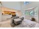Cozy living room with view into kitchen, large bay windows, and comfortable sofa at 11803 E 114Th Pl, Commerce City, CO 80640