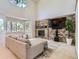 Bright living room featuring stone fireplace with large entertainment center at 11803 E 114Th Pl, Commerce City, CO 80640