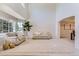Open-concept living room with vaulted ceilings, neutral decor, and large windows at 11803 E 114Th Pl, Commerce City, CO 80640