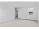 Spacious bedroom with plush carpet, large windows and a doorway leading to the ensuite bathroom at 223 Washington St, Erie, CO 80516