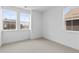 Bright bedroom with neutral carpet, and two large windows with views at 223 Washington St, Erie, CO 80516