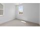 A bright bedroom features neutral carpet, and a large window at 223 Washington St, Erie, CO 80516