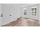 Neutral bedroom featuring two windows, a closet and hardwood flooring at 223 Washington St, Erie, CO 80516
