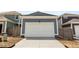 Detached garage with clean white door and concrete driveway at 223 Washington St, Erie, CO 80516