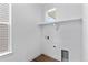 Clean and bright laundry room with window, shelf, and hookups at 223 Washington St, Erie, CO 80516