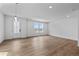 Bright and airy living room featuring hardwood floors, recessed lighting, and a modern front door at 223 Washington St, Erie, CO 80516