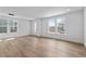 Spacious living room with hardwood floors, large windows, and contemporary lighting fixtures at 223 Washington St, Erie, CO 80516