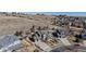 Aerial view of a gray roofed home with a trampoline and fenced yard surrounded by open spaces at 7734 Terry Ct, Arvada, CO 80007