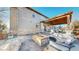 Covered patio in backyard featuring stone fire pit and comfortable seating at 7734 Terry Ct, Arvada, CO 80007