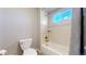 Bright bathroom showing tile shower, a window, and a toilet at 7734 Terry Ct, Arvada, CO 80007