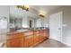 Bathroom with double vanity, granite countertops, and bright lighting at 7734 Terry Ct, Arvada, CO 80007