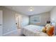 Neutral bedroom showcasing a geometrically patterned bed and a doorway to the bathroom at 7734 Terry Ct, Arvada, CO 80007