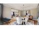 Elegant dining room featuring a modern chandelier, a large table with seating for six, and stylish decor at 7734 Terry Ct, Arvada, CO 80007