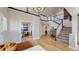 Grand foyer featuring high ceilings, an elegant chandelier, and an open staircase with black and white railings at 7734 Terry Ct, Arvada, CO 80007