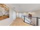 Upstairs hallway featuring neutral paint, plush carpet and open railing at 7734 Terry Ct, Arvada, CO 80007