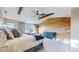 Comfortable main bedroom featuring wood accent wall and ample natural light at 7734 Terry Ct, Arvada, CO 80007