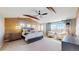 Spacious main bedroom with wood accent wall, ceiling beams, and sitting area by window at 7734 Terry Ct, Arvada, CO 80007