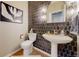 The stylish powder room features patterned tile backsplash, a pedestal sink and modern lighting at 7734 Terry Ct, Arvada, CO 80007